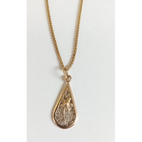 124 - 9ct gold pendant on 20