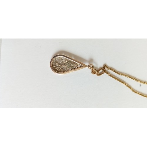 124 - 9ct gold pendant on 20