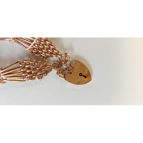 128 - Fully hallmarked 9ct rose gold tapered gate bracelet with heart padlock 23.8g approx. complete with ... 