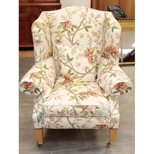 255 - Wing back library chair with frontal brass castors