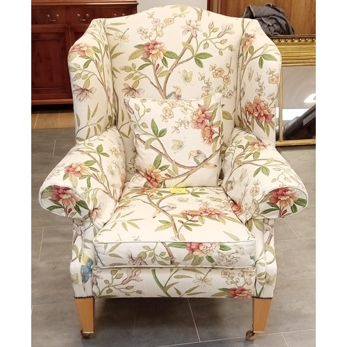 255 - Wing back library chair with frontal brass castors