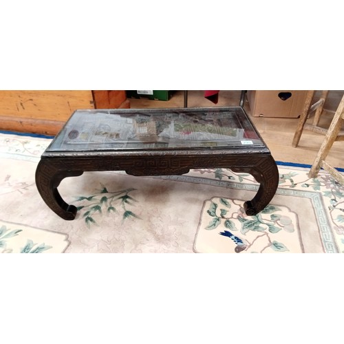 295 - Oriental carved coffee table with glass inlay