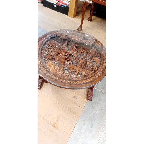 285 - Oriental circular carved with glass top fold away coffee table