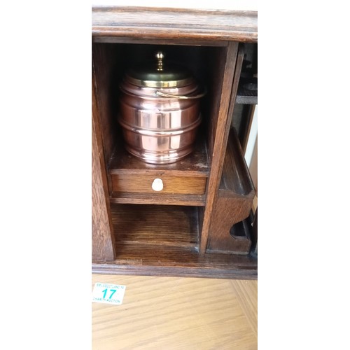 17 - Oak smokers cabinet with removable pipe rack, copper and brass tobacco jar