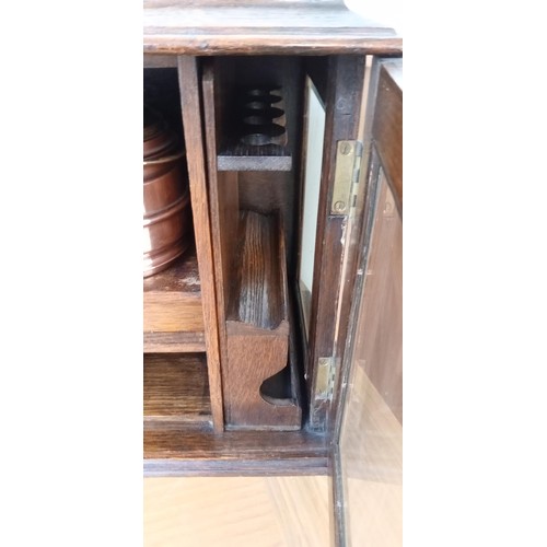 17 - Oak smokers cabinet with removable pipe rack, copper and brass tobacco jar