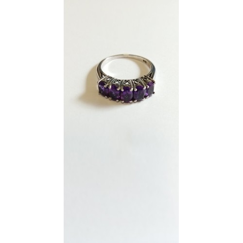 130 - Silver hallmarked and purple stone on a bridge ring size O approx.