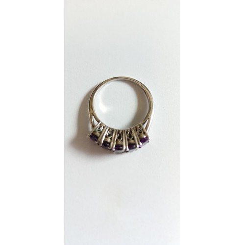 130 - Silver hallmarked and purple stone on a bridge ring size O approx.