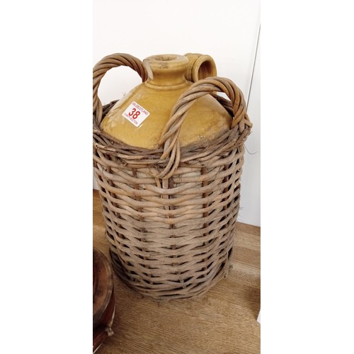 38 - Flagon in wicker basket & 1 other