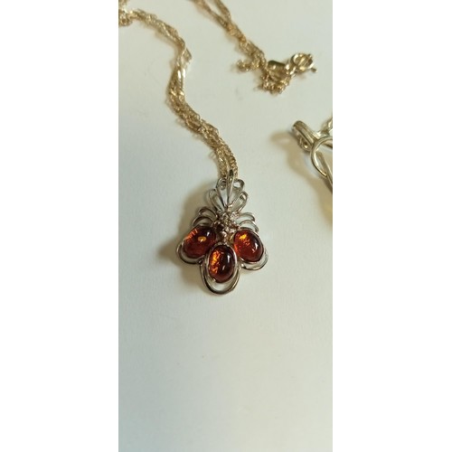 242 - Pair of sterling silver and amber necklaces