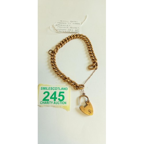 245 - Yellow metal marked 15 charm bracelet with padlock broken. 18g approx. from a deceased estate