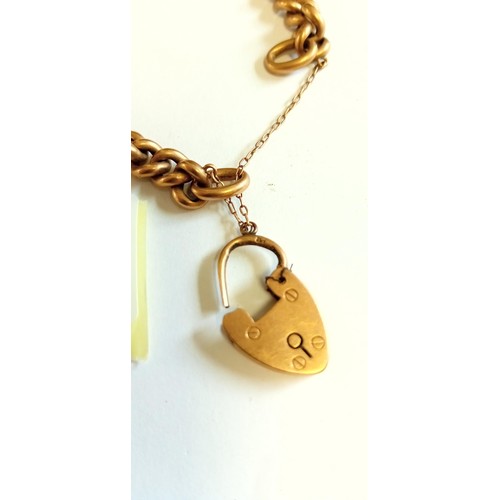 245 - Yellow metal marked 15 charm bracelet with padlock broken. 18g approx. from a deceased estate