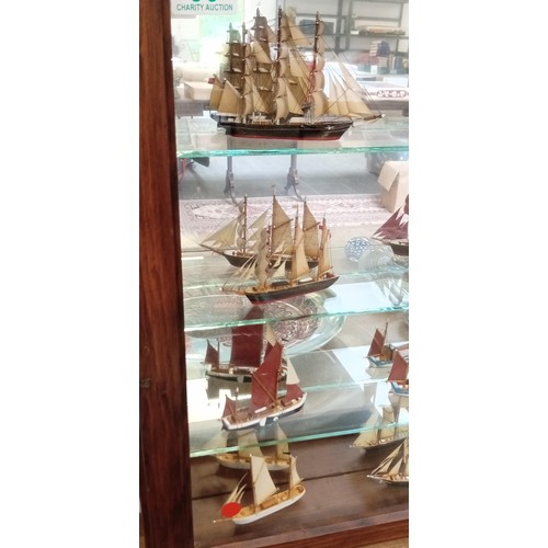 39 - Glass presentation cabinet with 12 model boats in Cornwall 1976