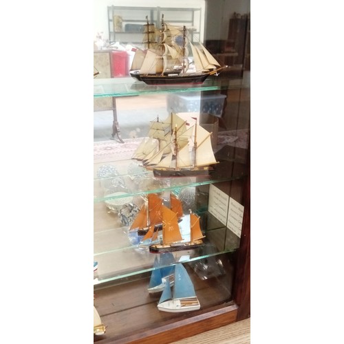 39 - Glass presentation cabinet with 12 model boats in Cornwall 1976