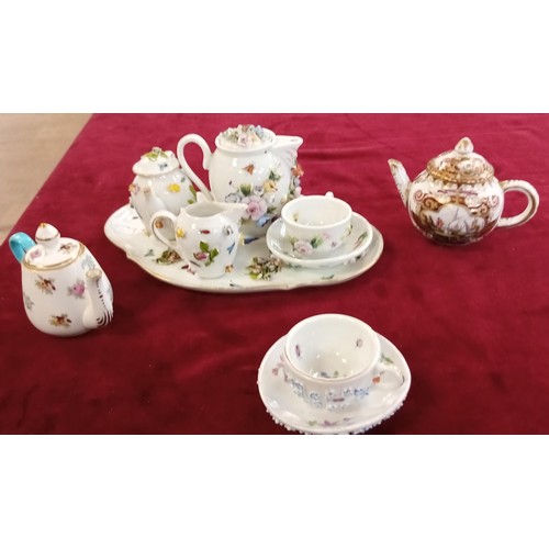 111 - Miniature raised tea set and others