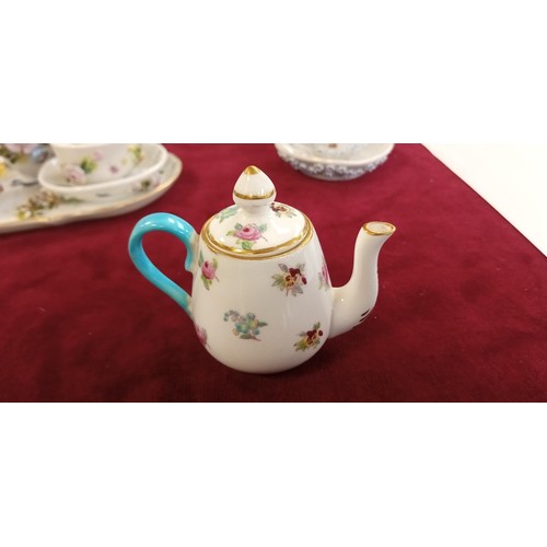 111 - Miniature raised tea set and others