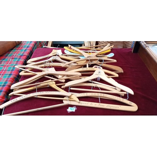 397 - Large selection of wooden coat hangers to include Savoy Hotel, White Horse Whisky, Woodstock hotel a... 