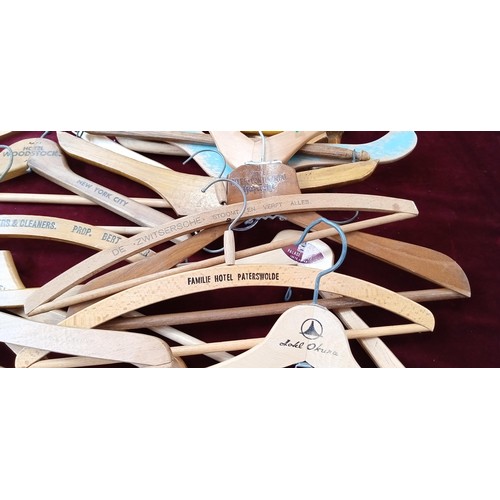 397 - Large selection of wooden coat hangers to include Savoy Hotel, White Horse Whisky, Woodstock hotel a... 