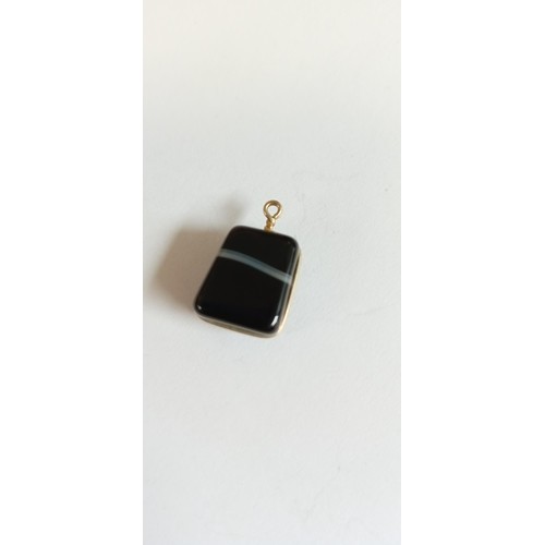 64 - 9ct gold and Black gemstone charm total weight 4.2g