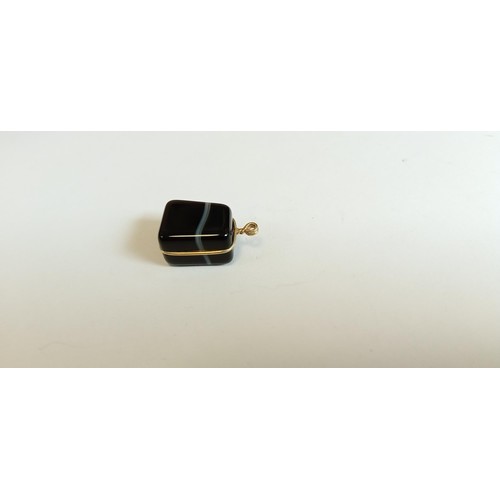 64 - 9ct gold and Black gemstone charm total weight 4.2g