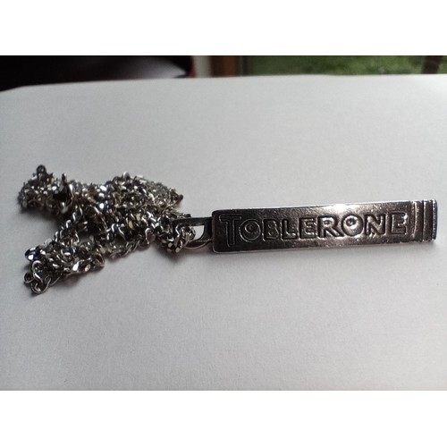 85 - Silver hallmarked Toblerone pendant on a sterling silver stamped 925 chain