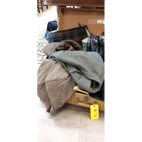 286 - Case full of tartan, tweed, wool and cashmere kilts and clothing