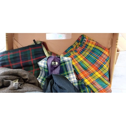 286 - Case full of tartan, tweed, wool and cashmere kilts and clothing