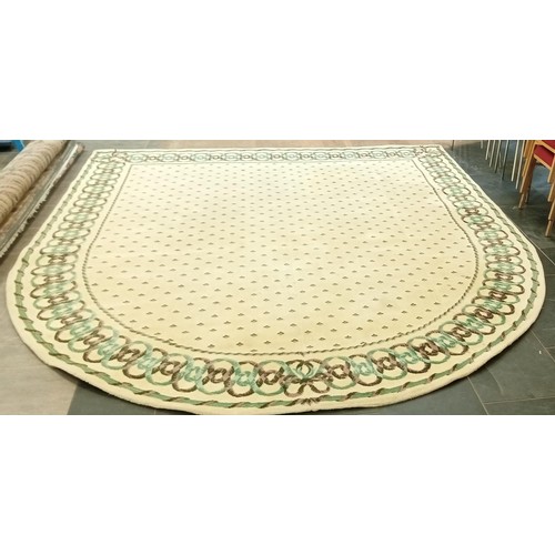 374 - Large cream rug with half-moon at one end measures 309cm x 282cm approx.