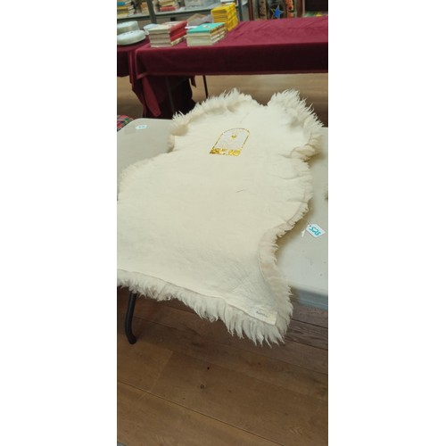 525 - Genuine sheepskin rug measures 1m long approx.