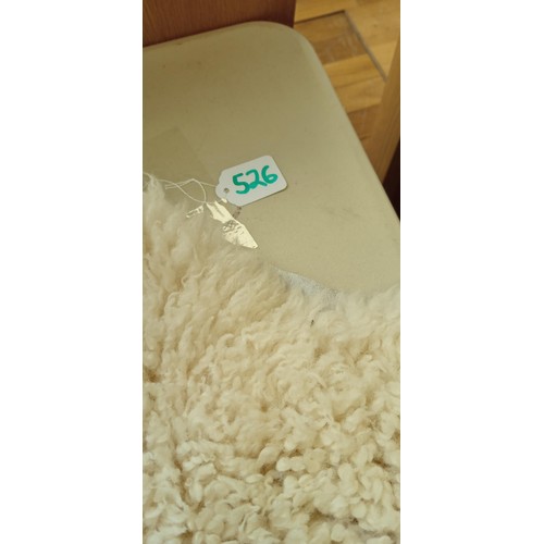 526 - Sheepskin rug measures 90cm long approx.