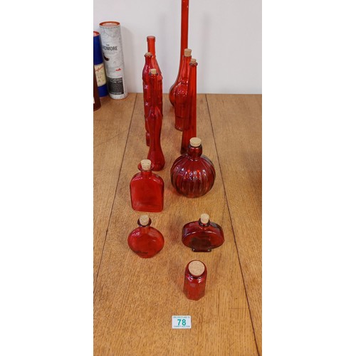 78 - Selection of red glass bottles