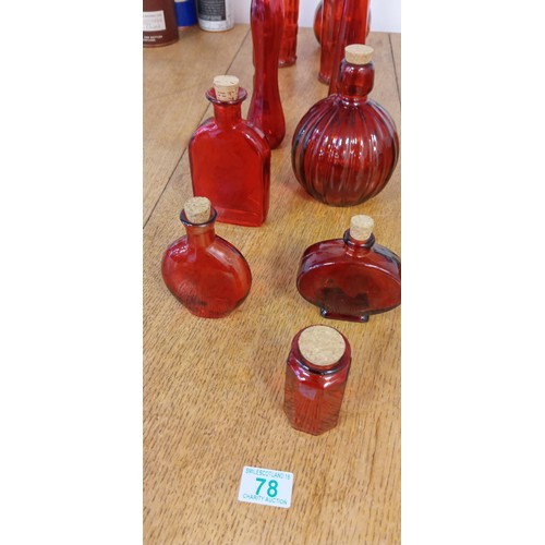 78 - Selection of red glass bottles