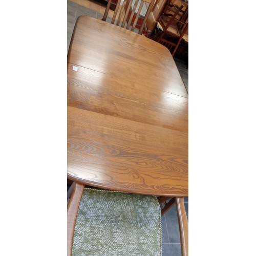 252 - Extending Ercol dining table with 4 Ercol chairs, 2 carvers and 2 normal