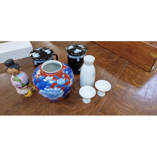 265 - Noritake saki drinking set, Japanese mugs, vase and figurine