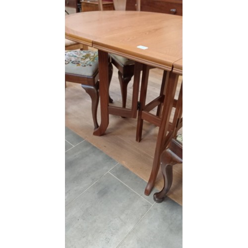 294 - Folding double leafed gate leg dining table plus 4 chairs