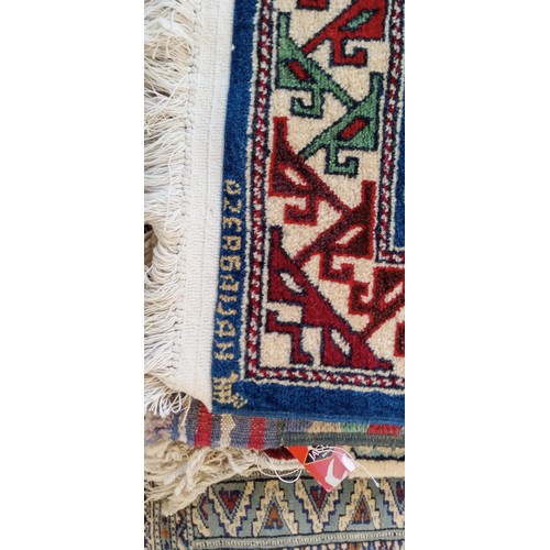 17 - Handmade Azerbaijan rug signed with blue field and cream motifs 130cm x 80cm approx.