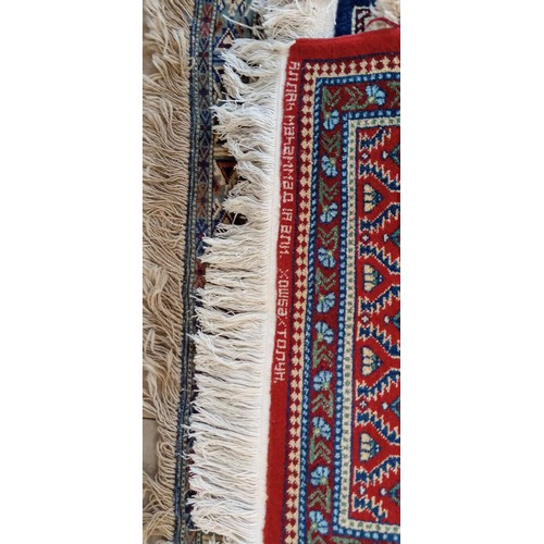 19 - Handmade Azerbaijan rug with red field dated 1990 and signed with geometric design 136cm x 62cm appr... 