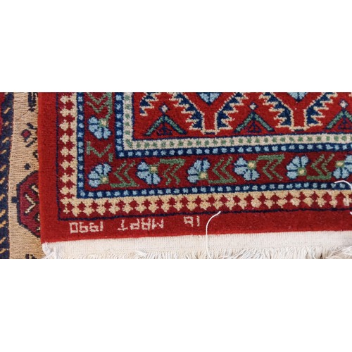 19 - Handmade Azerbaijan rug with red field dated 1990 and signed with geometric design 136cm x 62cm appr... 