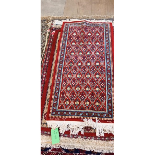 19 - Handmade Azerbaijan rug with red field dated 1990 and signed with geometric design 136cm x 62cm appr... 