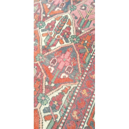 212 - Handmade rug well worn multi coloured beige and reds 190cm x 143cm approx.