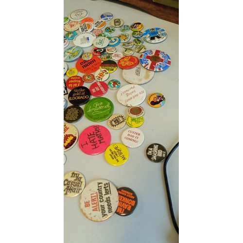 24 - Selection of vintage badges on places and slogans mainly