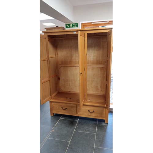 137 - Oak 3 door wardrobe with 2 drawer base measures 134cm W x 184cm H x 53cm D approx.