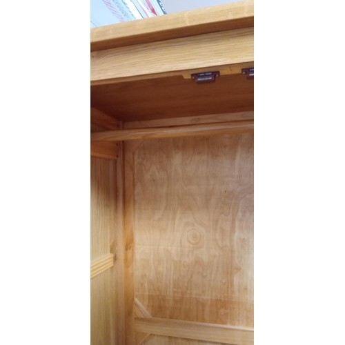 137 - Oak 3 door wardrobe with 2 drawer base measures 134cm W x 184cm H x 53cm D approx.