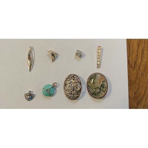 26 - 8 Silver pendants or brooches