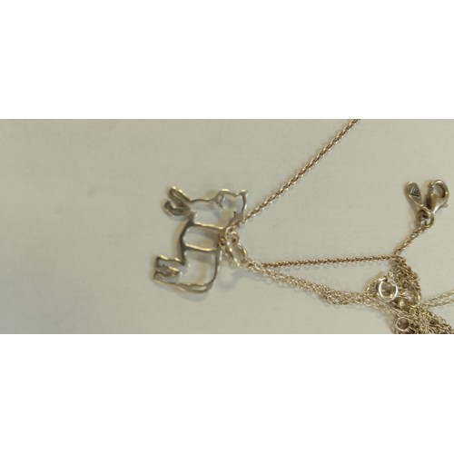 29 - Silver bracelet & 2 silver necklaces 1 with a bull and 1 with cross (need unravelled)