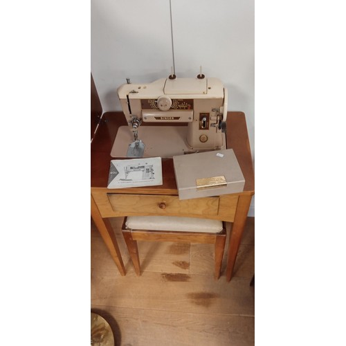 31 - Slant-o-matic Singer sewing machine in folding out table and stool