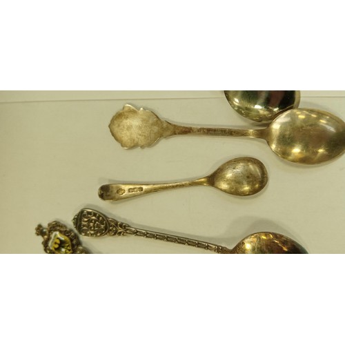 101 - 9 teaspoons plus a pickle fork some marked silver from different continents