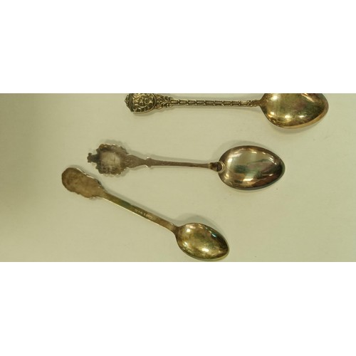 101 - 9 teaspoons plus a pickle fork some marked silver from different continents