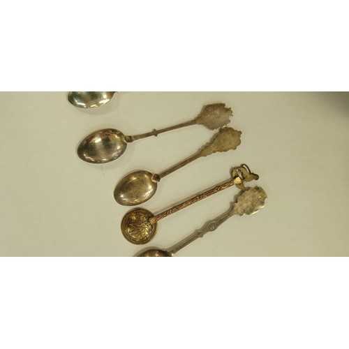 102 - 10 teaspoons some marked silver from different continents