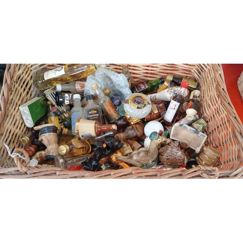 192 - Wicker basket full of ceramic and glass bottle miniatures