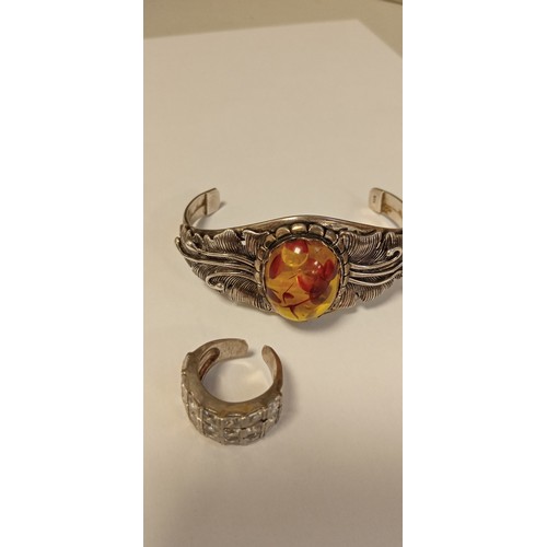 79 - 925 stamped decorative bangle with possible amber inlaid stone plus white metal ring